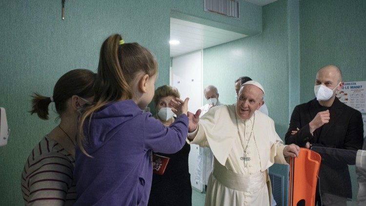 Pope Francis waves to young patients