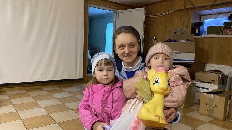 Sister Svitlana Matsiuk with two Ukrainian children