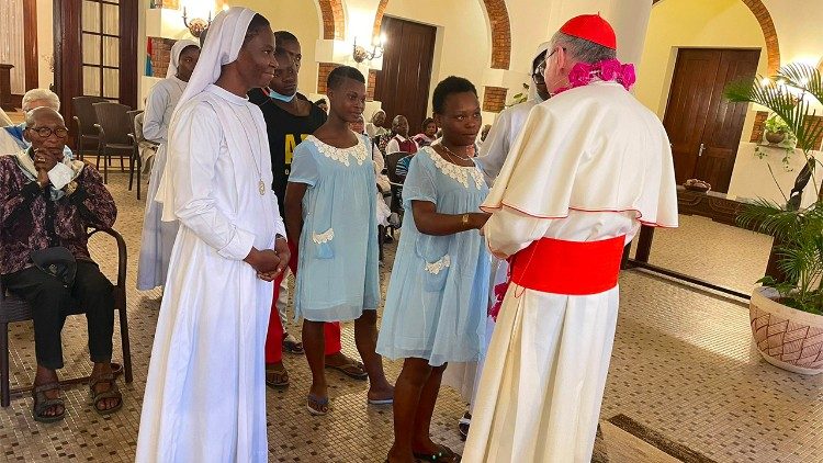 Cardinal Paroline greets the two young women