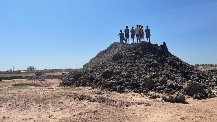 Children on a mound of earth