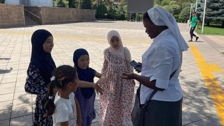 A religious sister teaches a group of young Muslims 