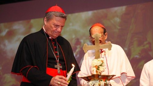 Cardinal Mario Grech lights a candle at a recent event in India (© Synod.va)