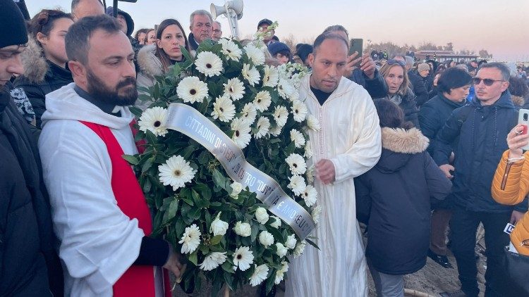 The Imam and a Priest throw a wreath of flowers into the sea