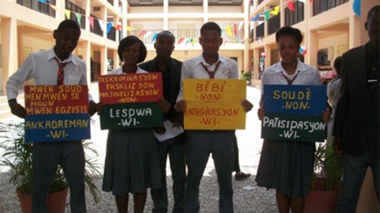 Students hold placards denouncing discrimination