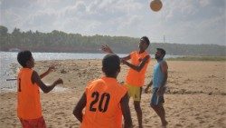 LiFFA players practising football with coach Cleofas Alex [Blue jersey] near the coast of Kerela, India 