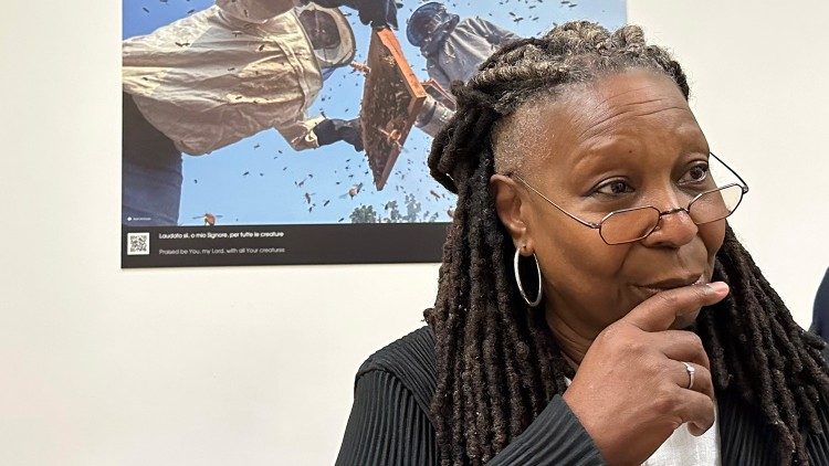 Whoopi Goldberg turns away after looking at a photo of beekeepers and their hive and suggests she send the Pope some bees