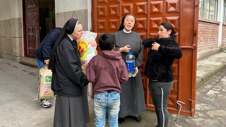 Religious sisters hand out food aid to residents