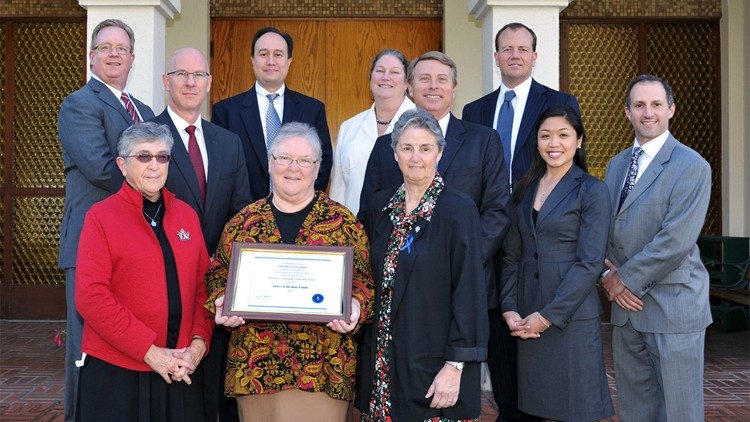 Sisters of the Holy Family Elaine Sanchez, Gladys Guenther, and Caritas Foster, surrounded by FBI representatives during a visit in 2012