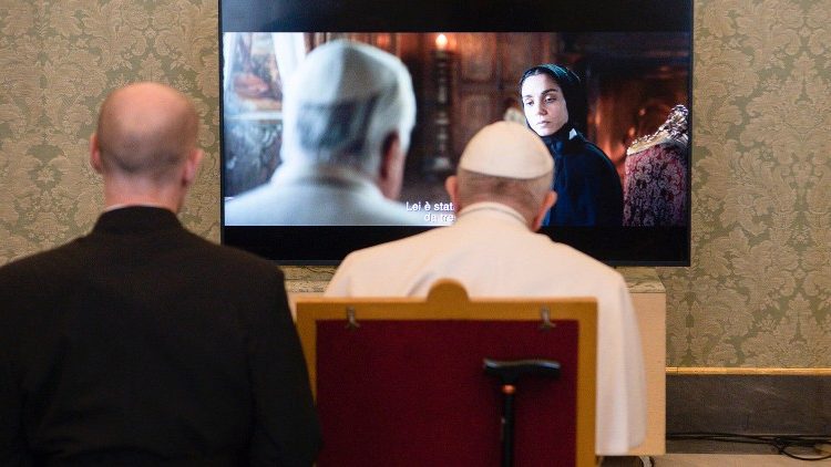 Pope Francis watches a scene from the film